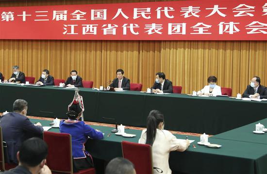 Li Zhanshu, a member of the Standing Committee of the Political Bureau of the Communist Party of China Central Committee and chairman of the National People's Congress (NPC) Standing Committee, joins deputies from Jiangxi Province in group deliberation at the third session of the 13th NPC in Beijing, capital of China, May 22, 2020. (Xinhua/Ding Lin)